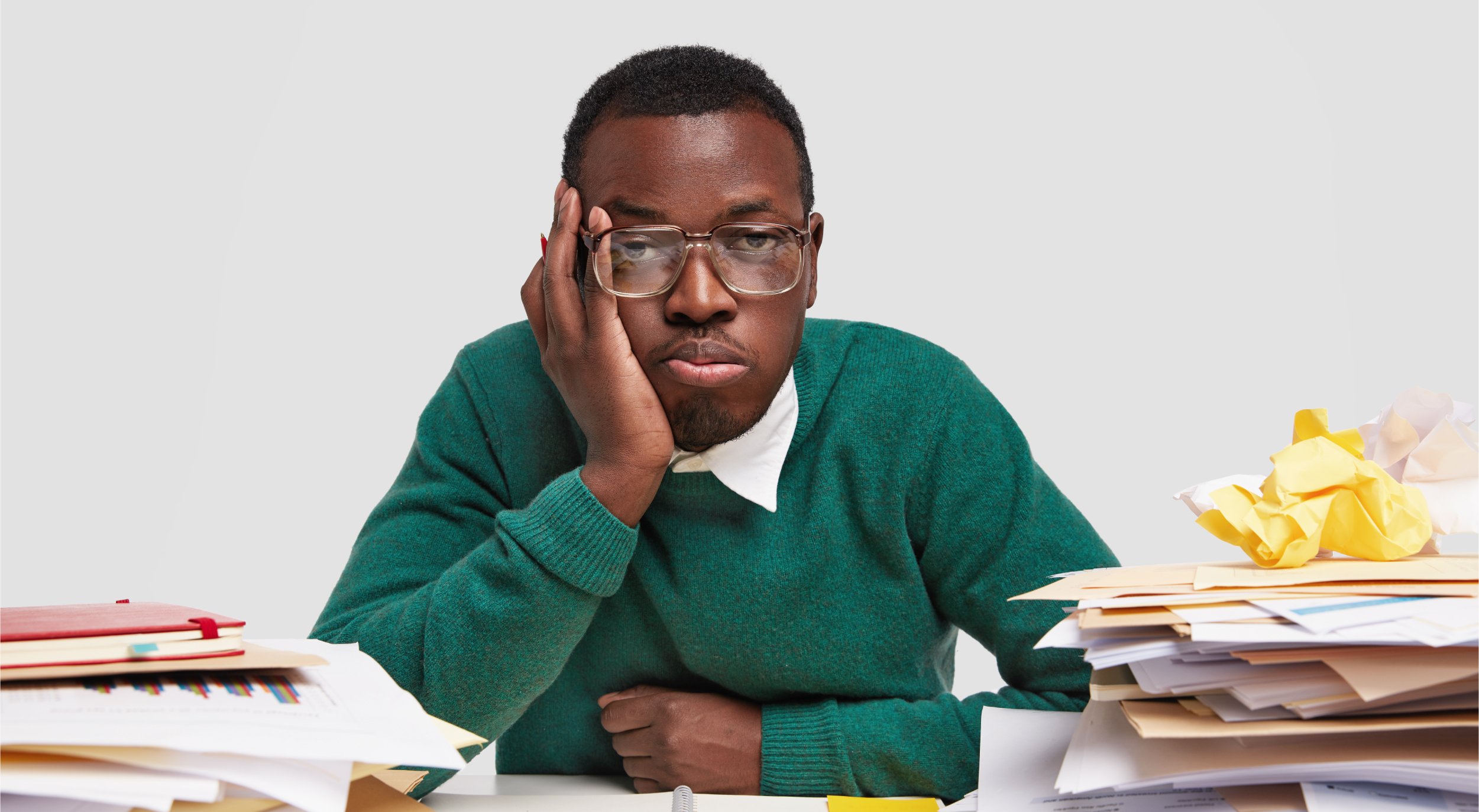 bored-male-worker-has-tired-facial-expression-looks-displeasure-works-long-hours-project-task-has-dark-healthy-skin-sticks-notes-notepad-32