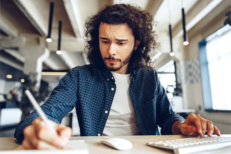handsome-curly-guy-is-making-notes-working-table-open-space-office_NBLOG copy-1