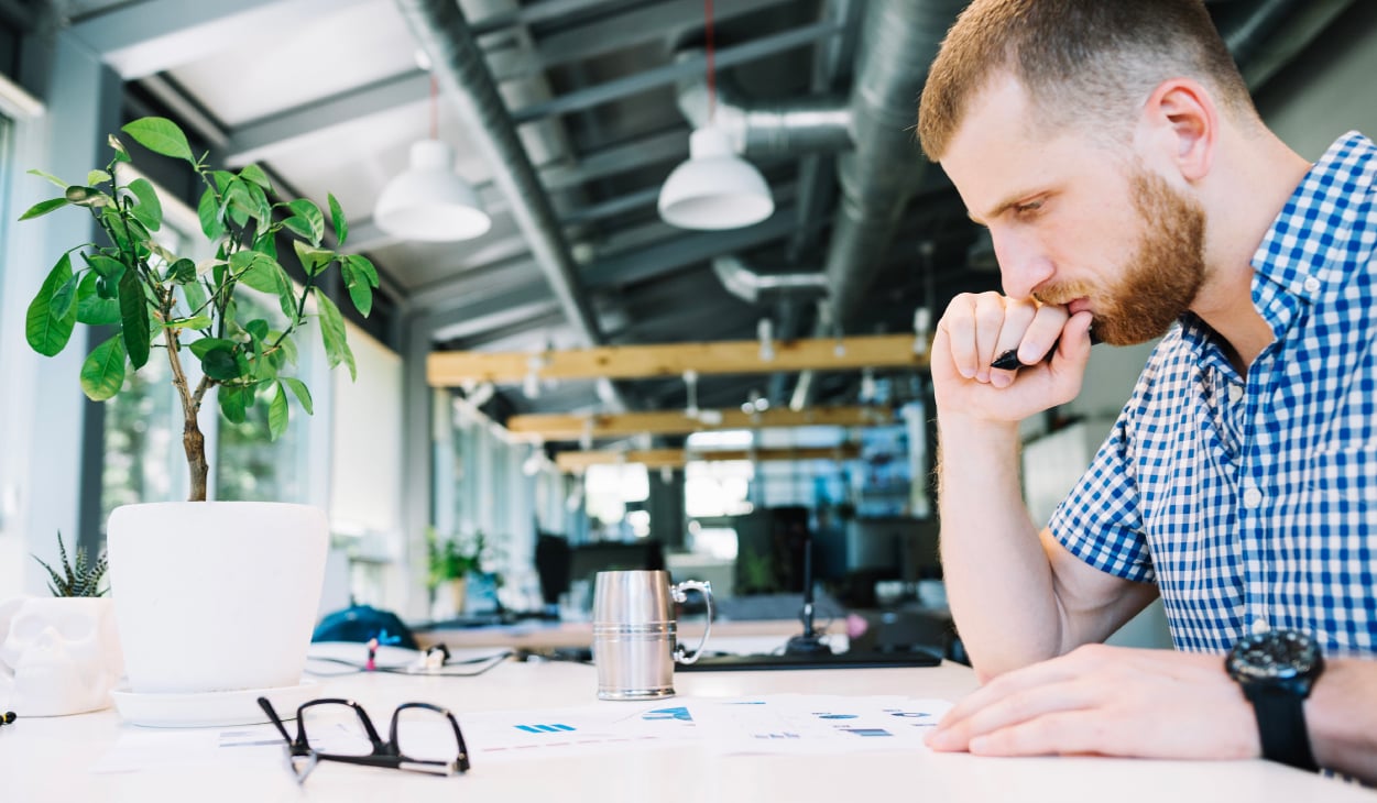 pensive man seriously thinking in an office | Botkeeper