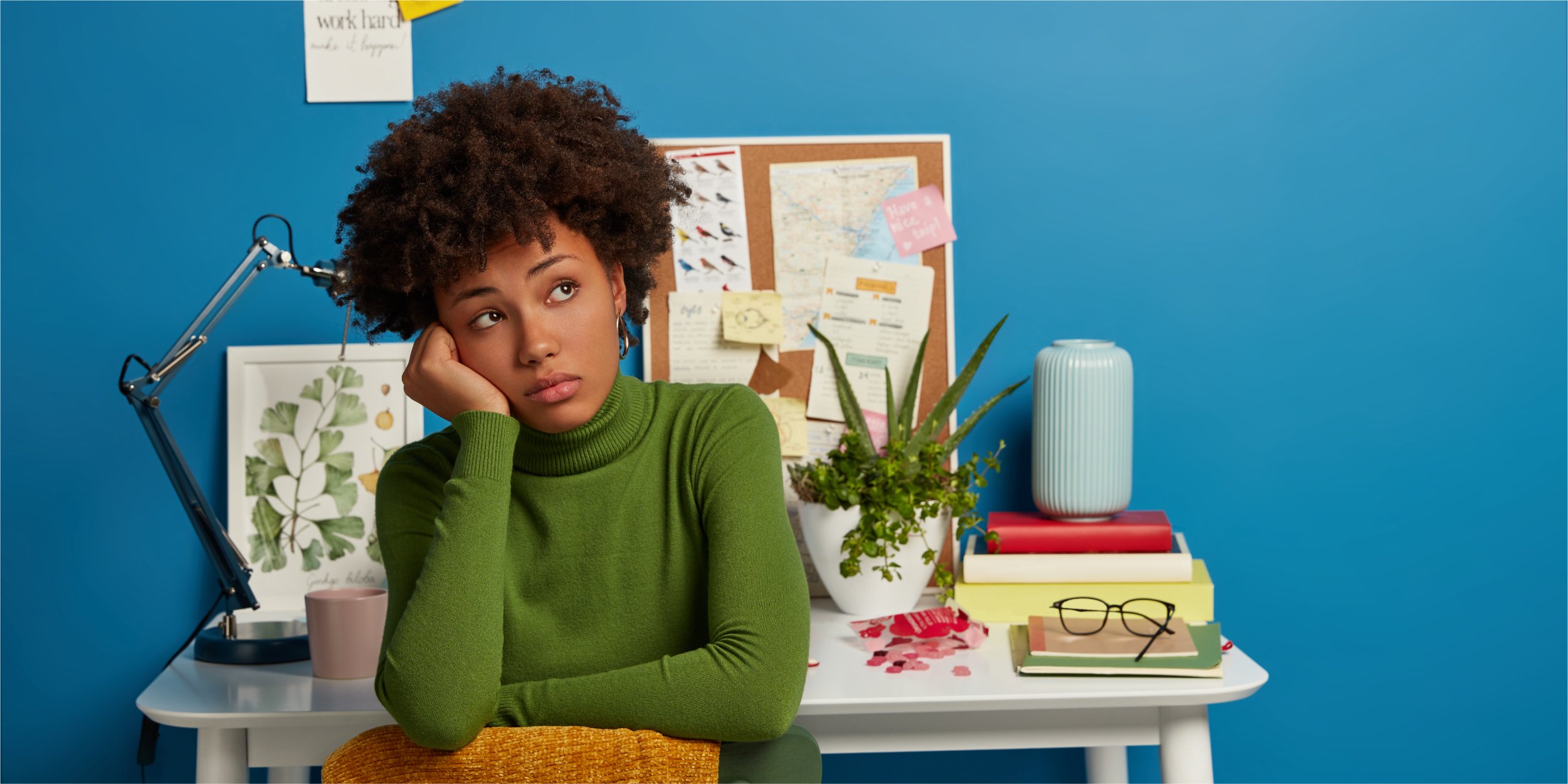 pensive-dark-skinned-lady-looks-away-dressed-green-turtleneck-has-rest-after-working-desktop-poses-home-against-blue-background_The Most Important Metric for Firm Growth Is Revenue Per Client—Here's Why_Botkeeper