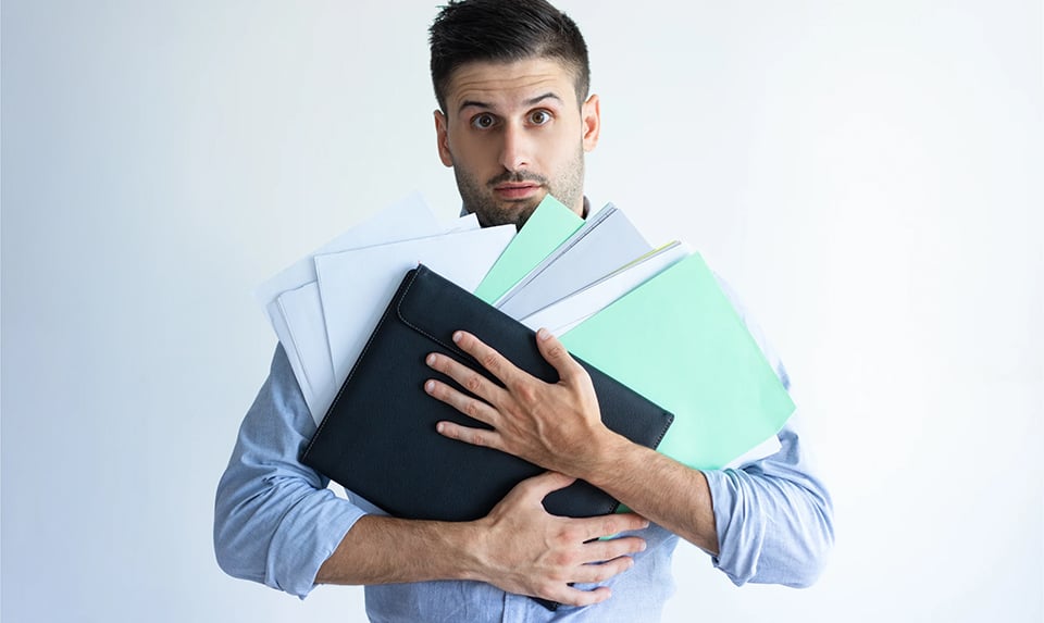 puzzled-office-worker-holding-pile-documents-32