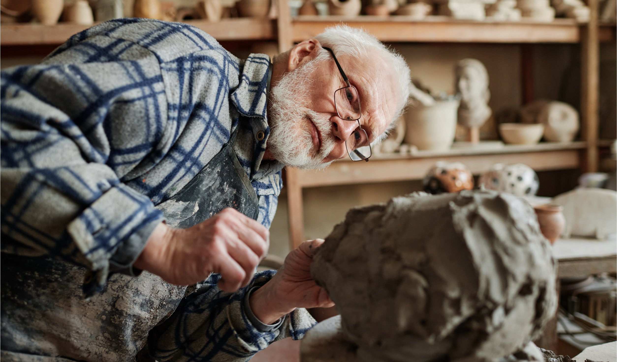 senior-man-concentrating-his-work-studio-he-making-ceramic-sculpture-wheel_Botkeeper