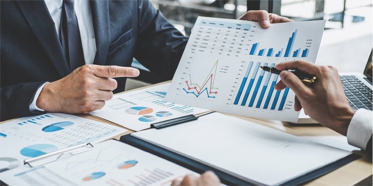 two-executive-discussing-company-growth-project-success-financial-statistics_Blog copy