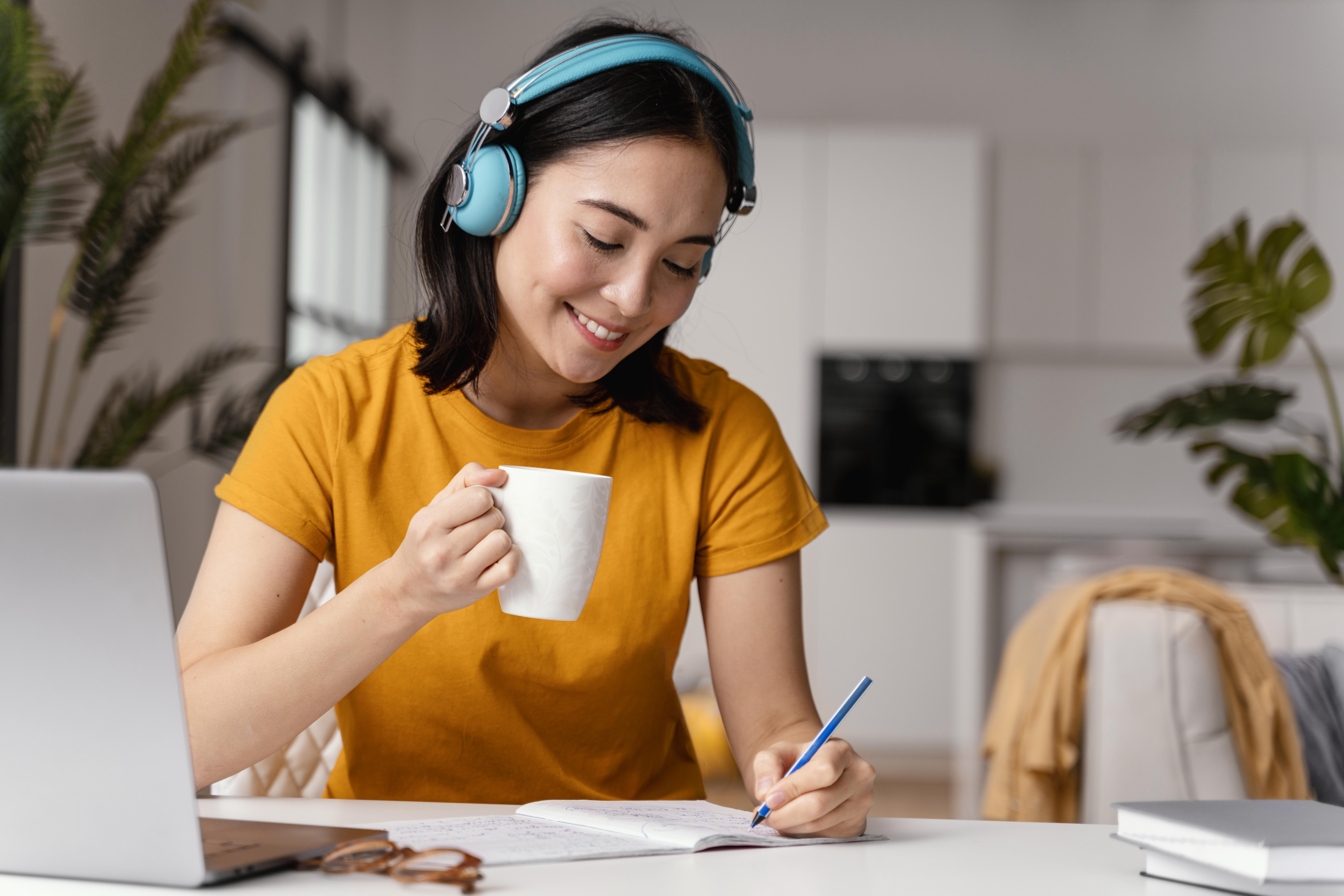woman-drinking-coffee-while-attending-online-class