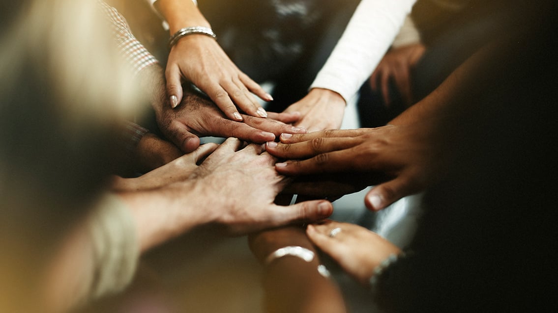 closeup-diverse-people-joining-their-hands-boteeper