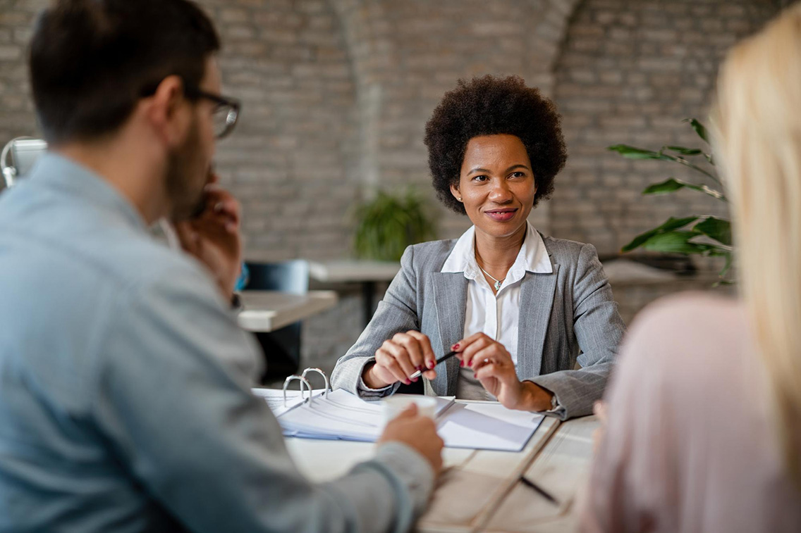 happy-african-american-financial-advisor-having-meeting-with-couple-office-botkeeper