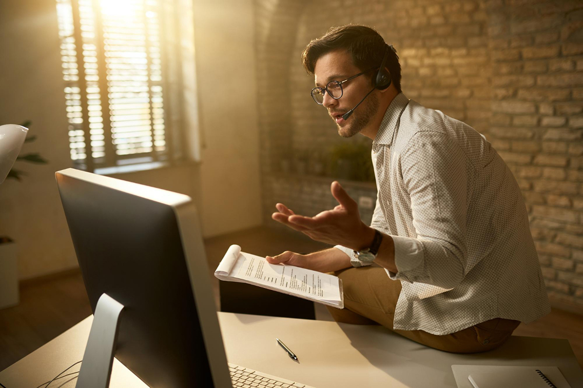 young-entrepreneur-talking-about-business-reports-while-having-video-conference-desktop-pc-office-botkeeper