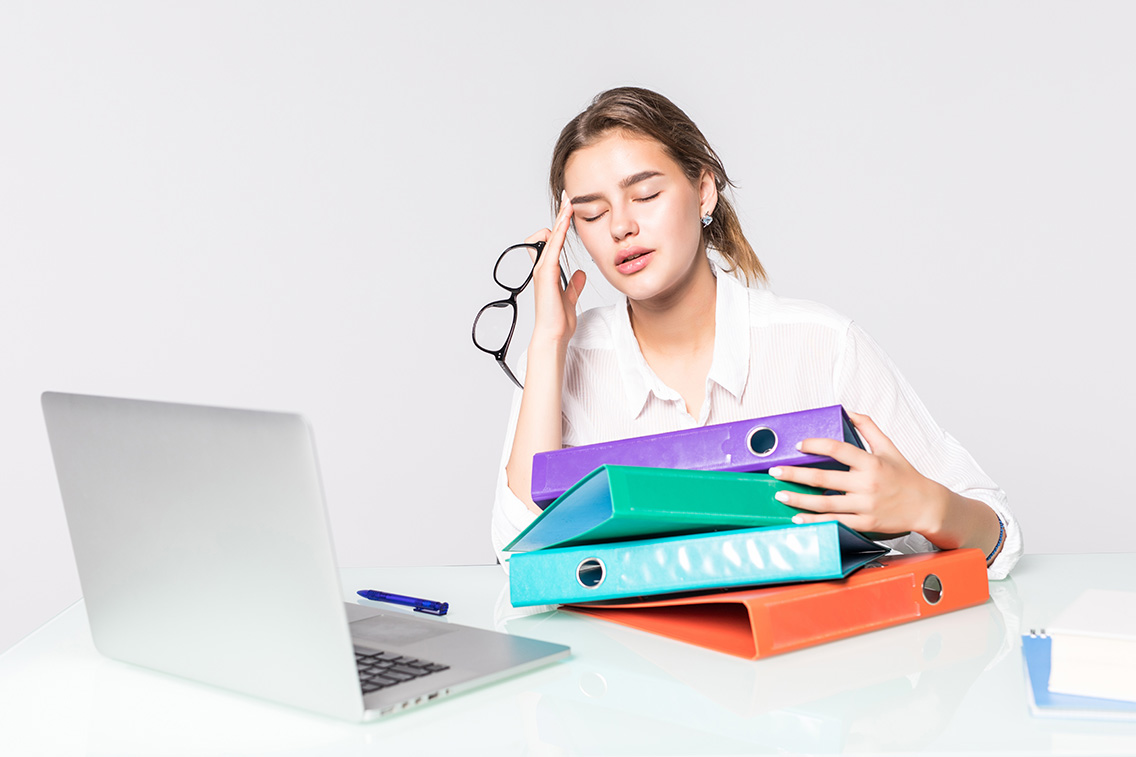 young-tired-business-woman-with-folders-office-desk-isolated-white-background-botkeeper