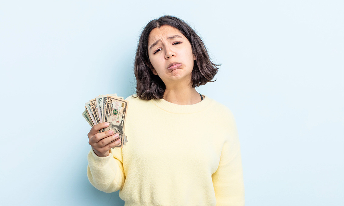 young-woman-feeling-sad-whiney-with-unhappy-look-crying-dollar-banknotes-concept_botkeeper2