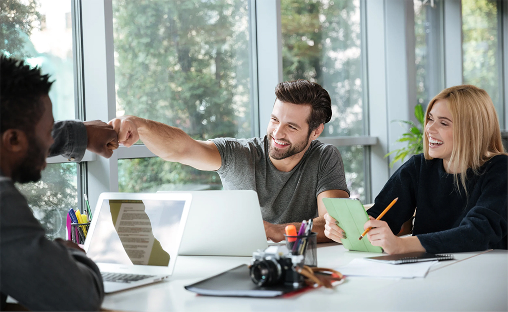 smiling-young-colleagues-sitting-office-coworking-16