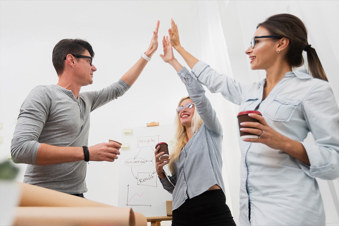 happy-business-partners-raising-hands