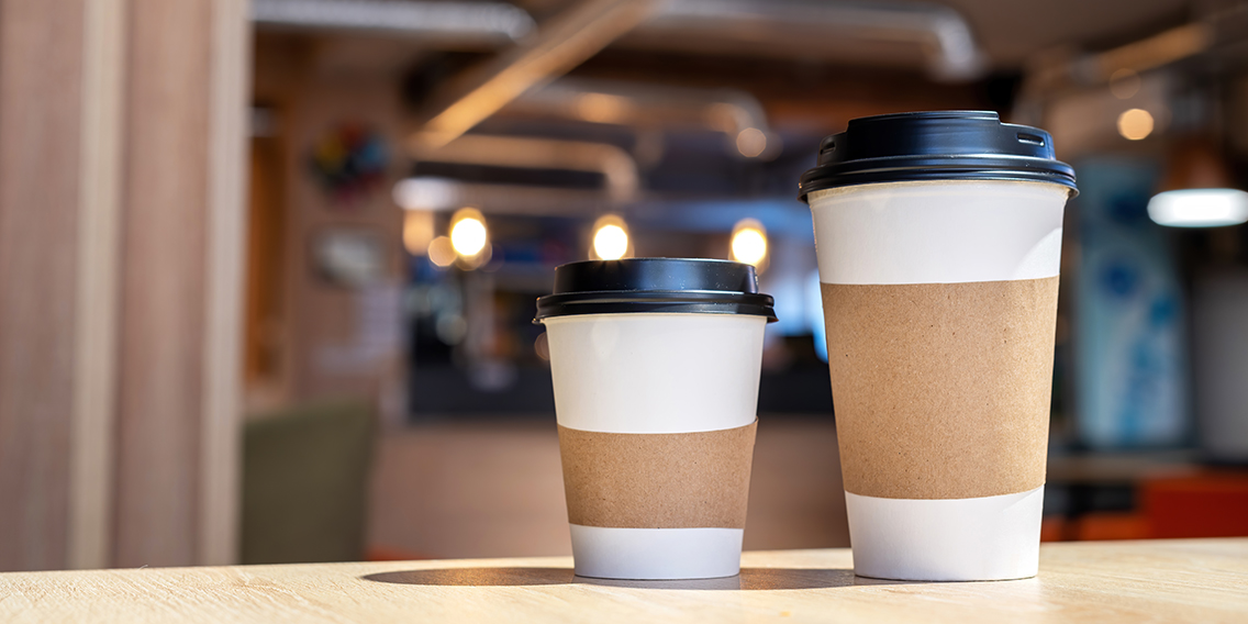 large-small-cup-coffee-wooden-table-cafe