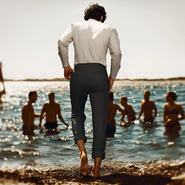 man tip toeing into the ocean