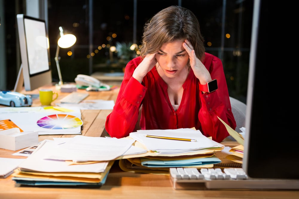 Stressed businesswoman sitting in front of computer in the office