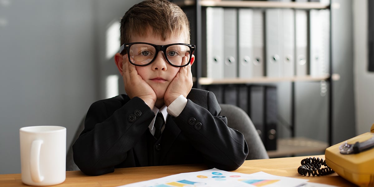 kid wearing big eye glasses in an office